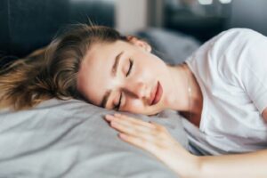 girl sleeping in white bed