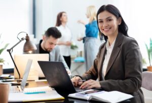 girl smiling and using laptop